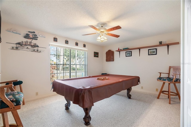 game room with a textured ceiling, ceiling fan, light carpet, and billiards