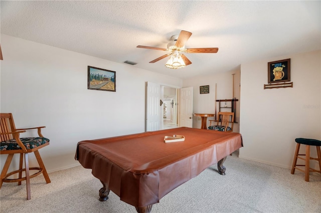 game room featuring ceiling fan, light colored carpet, a textured ceiling, and billiards