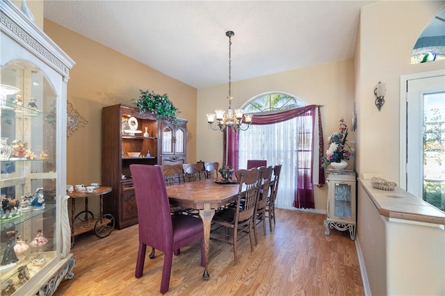 dining space featuring a notable chandelier and light hardwood / wood-style flooring