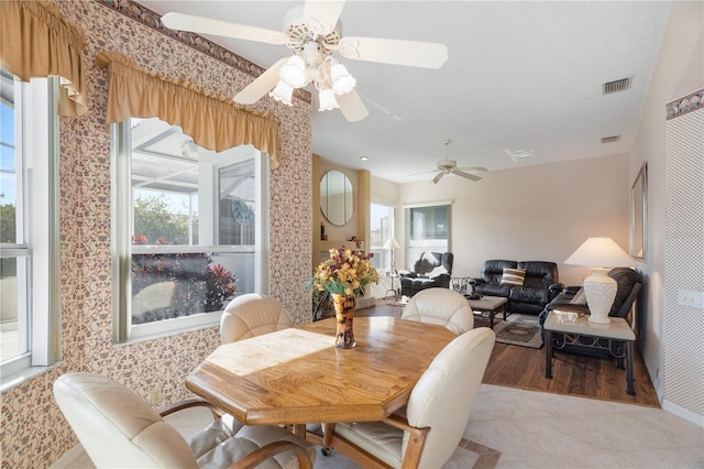 tiled dining space with ceiling fan