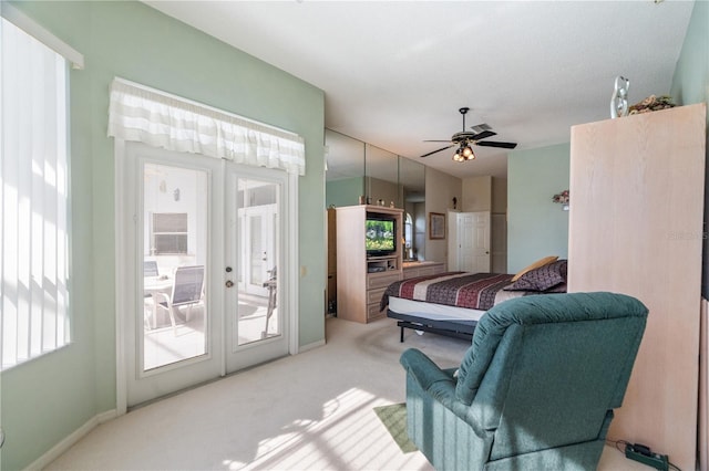 carpeted bedroom with ceiling fan, access to outside, and multiple windows