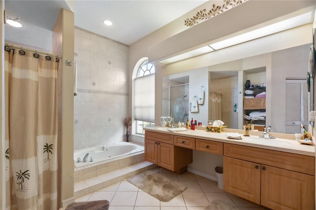 bathroom with tile patterned floors, vanity, and independent shower and bath