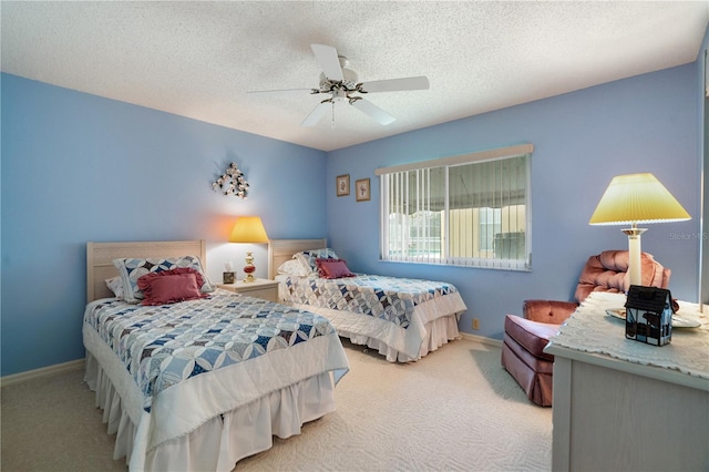 carpeted bedroom with ceiling fan and a textured ceiling