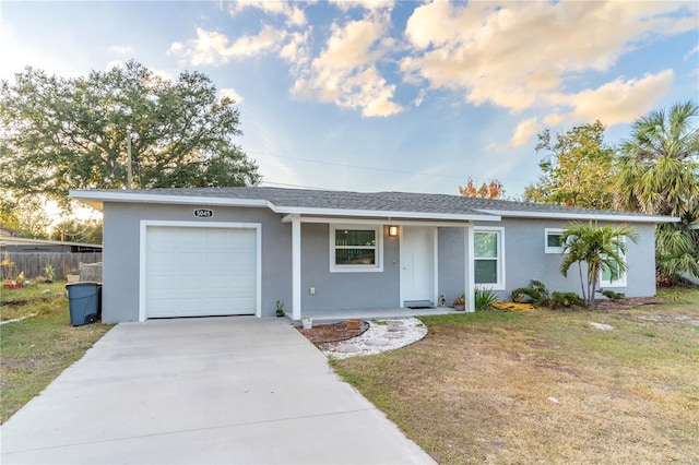 single story home with a front yard and a garage