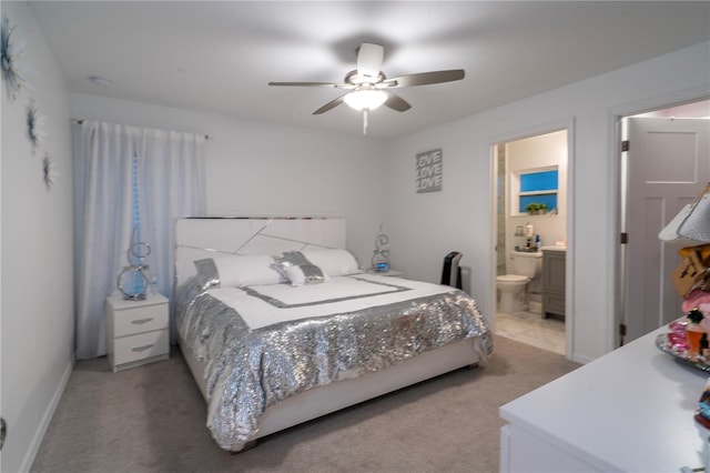 bedroom with carpet flooring, ensuite bath, and ceiling fan