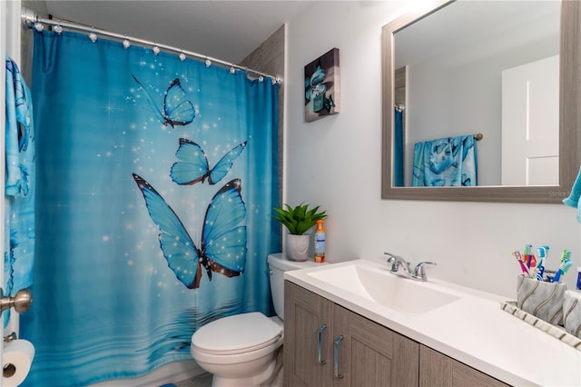 bathroom with vanity, toilet, and walk in shower