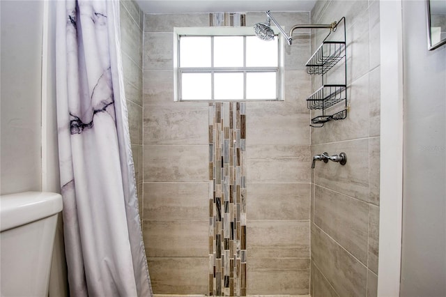 bathroom featuring toilet and walk in shower