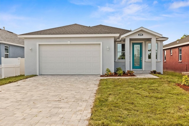 view of front of property with a garage and a front yard