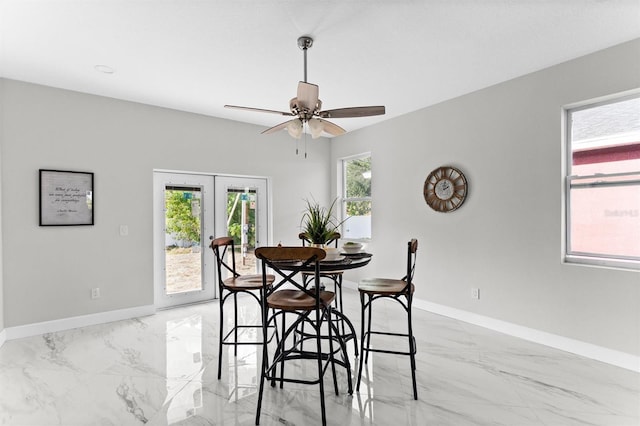 dining area with french doors and ceiling fan