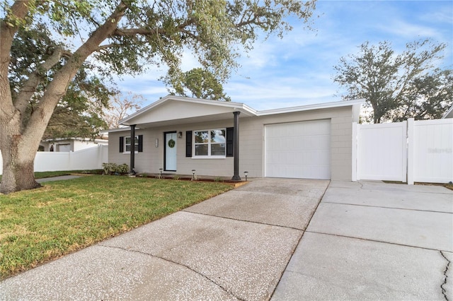 ranch-style home with a garage and a front lawn