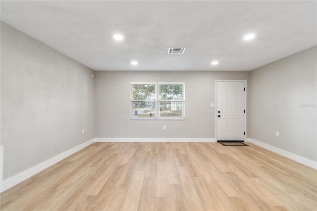 unfurnished room with light wood-type flooring