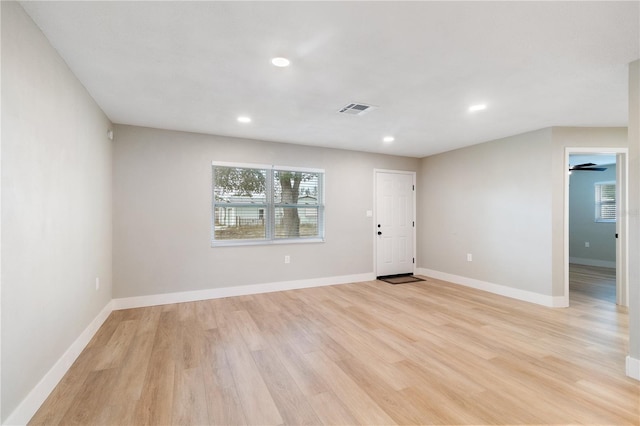 spare room featuring ceiling fan and light hardwood / wood-style flooring