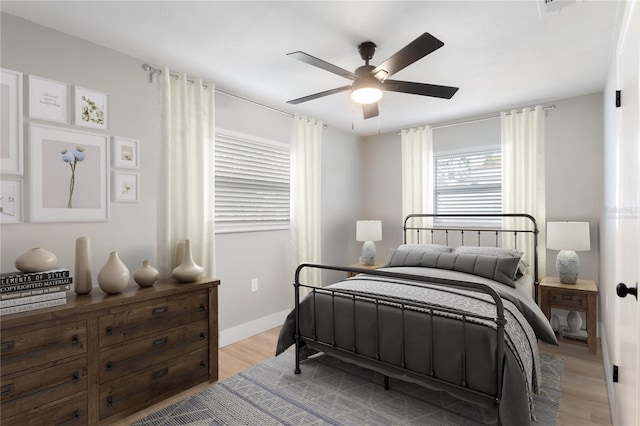 bedroom with light wood-type flooring and ceiling fan