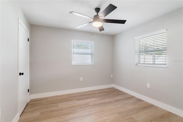 empty room with light hardwood / wood-style floors, ceiling fan, and a healthy amount of sunlight