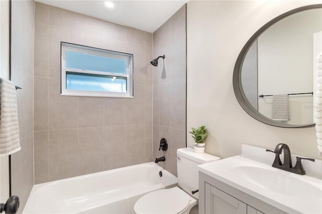 full bathroom featuring vanity, toilet, and tiled shower / bath