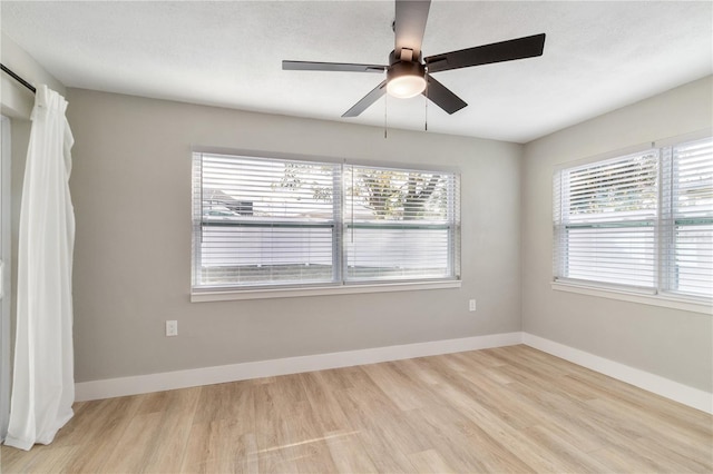 empty room with light wood-type flooring and ceiling fan