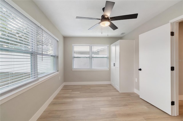 empty room with light hardwood / wood-style floors and ceiling fan