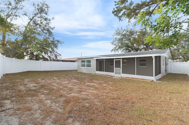 back of property with a sunroom