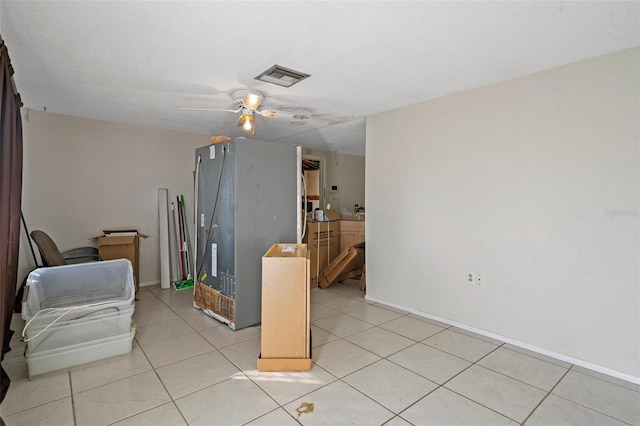 interior space with ceiling fan and a textured ceiling