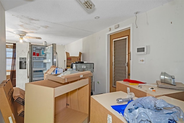 kitchen with a textured ceiling and ceiling fan