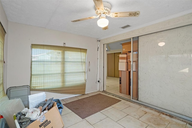 interior space with ceiling fan