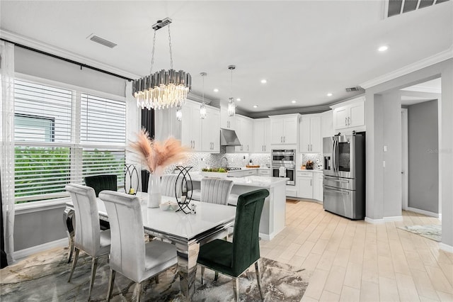 dining space with a chandelier and ornamental molding