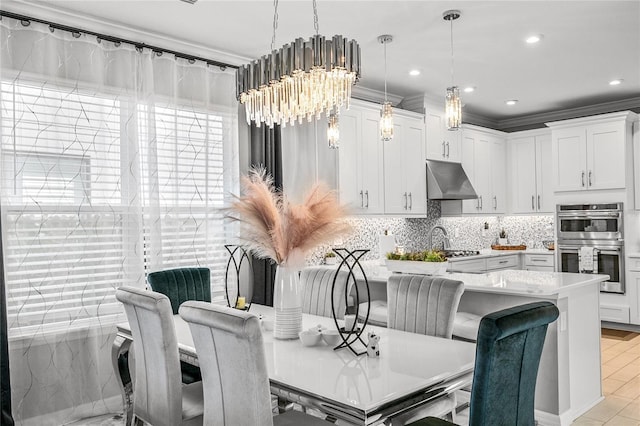 dining room featuring ornamental molding and an inviting chandelier