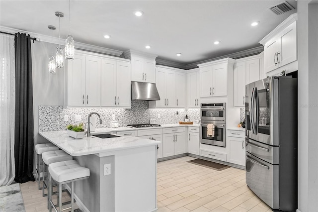 kitchen with white cabinets, sink, hanging light fixtures, kitchen peninsula, and stainless steel appliances