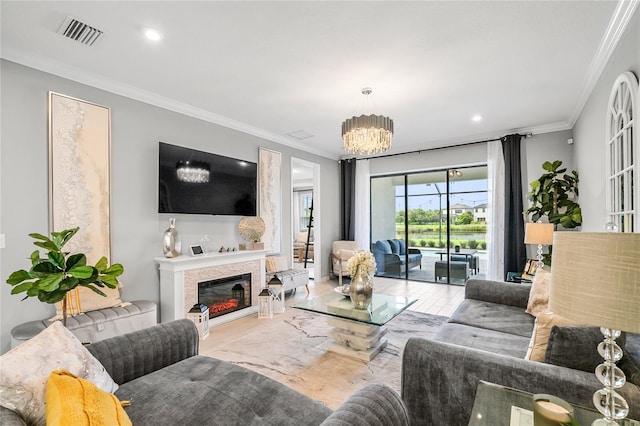 living room featuring a notable chandelier and ornamental molding