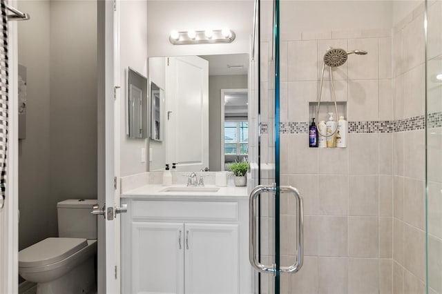 bathroom with vanity, toilet, and walk in shower