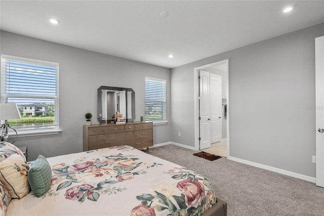 bedroom featuring light carpet