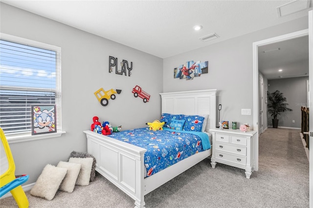 bedroom with carpet floors and multiple windows