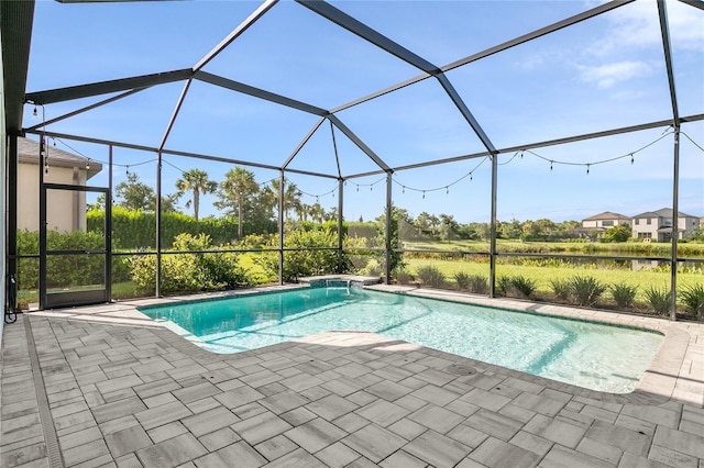 view of pool with glass enclosure and a patio