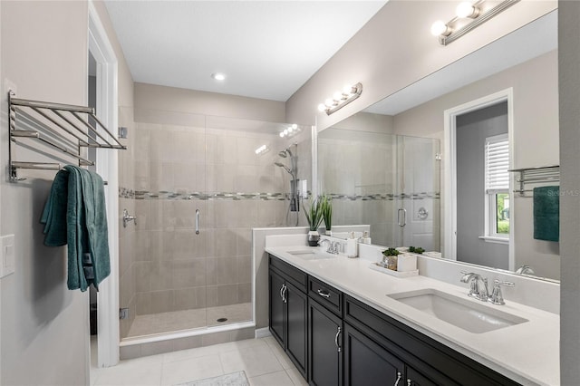 bathroom featuring tile patterned flooring, vanity, and a shower with door