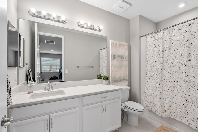 full bathroom featuring tile patterned flooring, shower / tub combo, vanity, and toilet