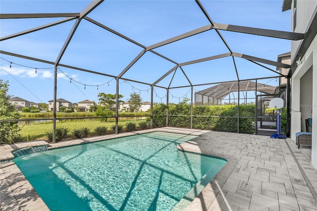 view of swimming pool featuring glass enclosure, pool water feature, and a patio area