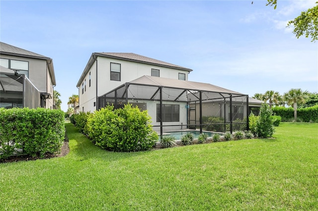 back of house with a yard and glass enclosure