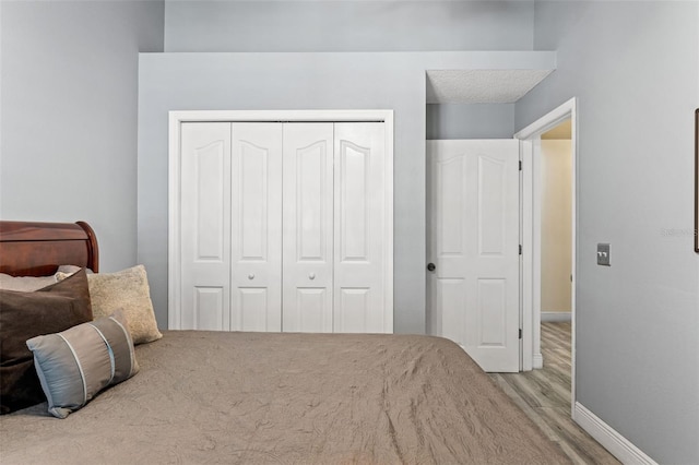 bedroom featuring a closet and light wood-type flooring