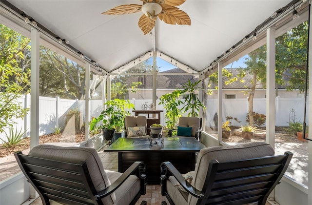 sunroom / solarium with ceiling fan and vaulted ceiling