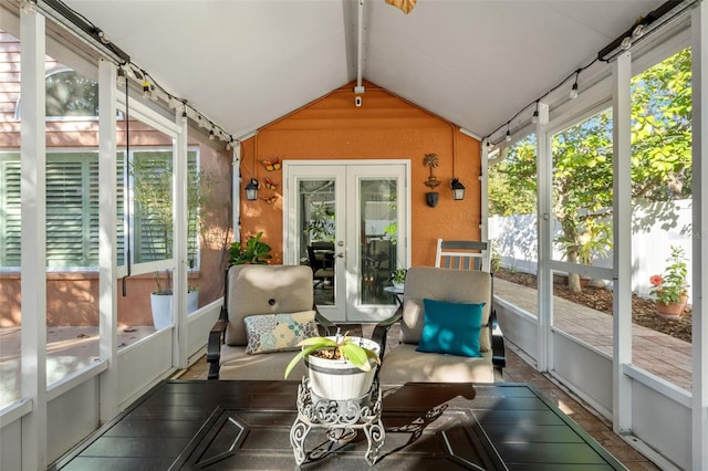 sunroom featuring french doors and vaulted ceiling