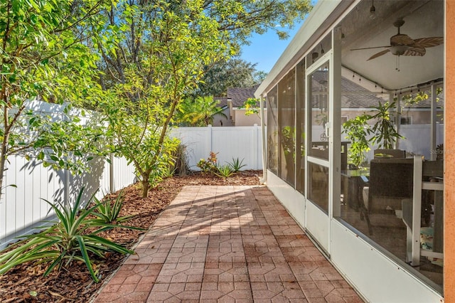 view of patio with a sunroom and ceiling fan