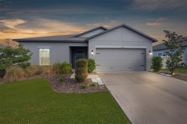 ranch-style home with a yard and a garage