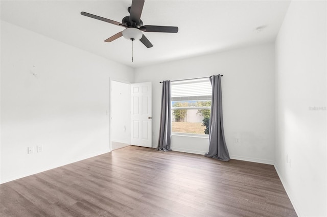 spare room featuring ceiling fan and hardwood / wood-style flooring