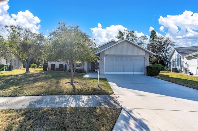 view of front of home with cooling unit, a garage, and a front yard