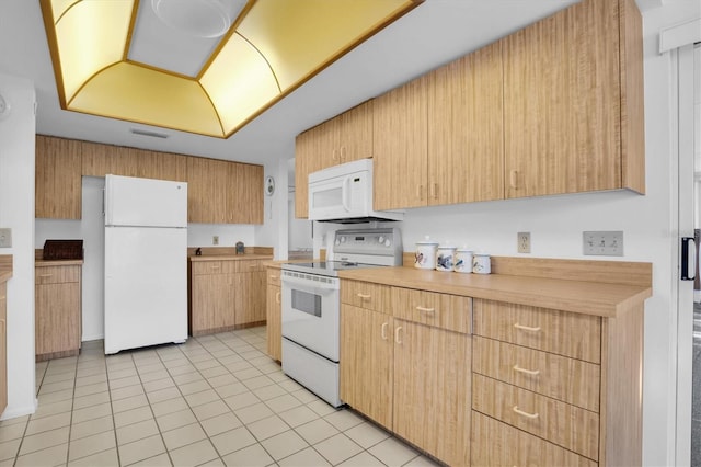 kitchen featuring white appliances and light tile patterned floors