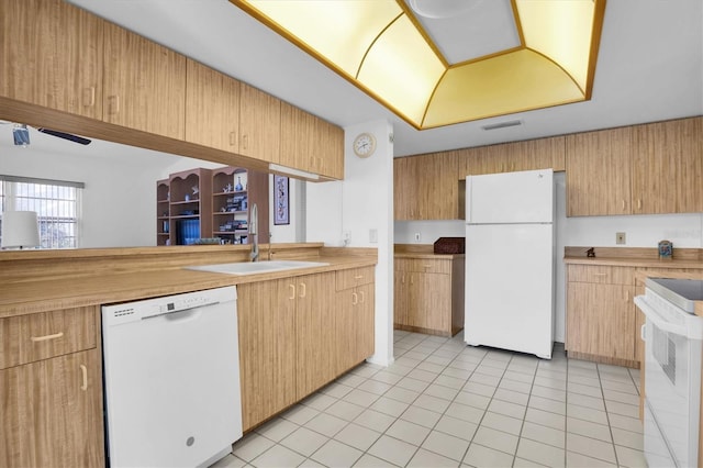 kitchen featuring sink, light tile patterned floors, and white appliances