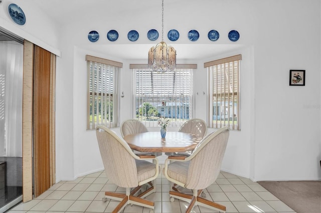 dining room featuring a notable chandelier and light tile patterned flooring