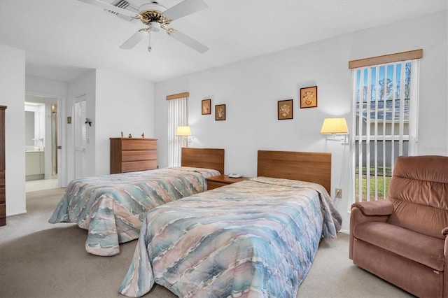 carpeted bedroom with ceiling fan and connected bathroom