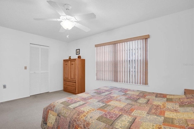 carpeted bedroom with a closet and ceiling fan