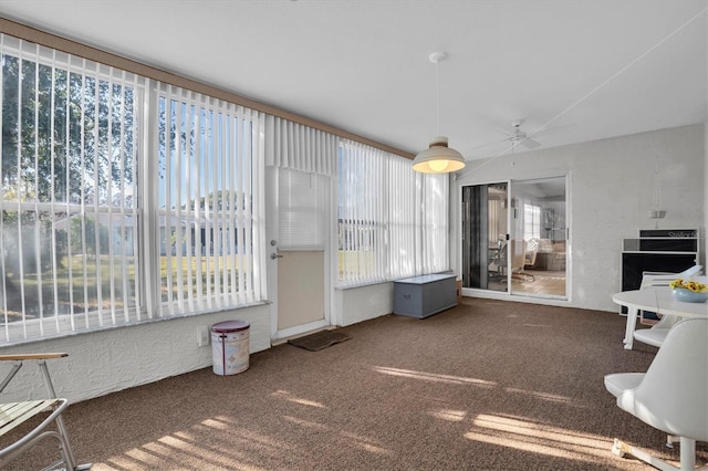 sunroom / solarium featuring ceiling fan